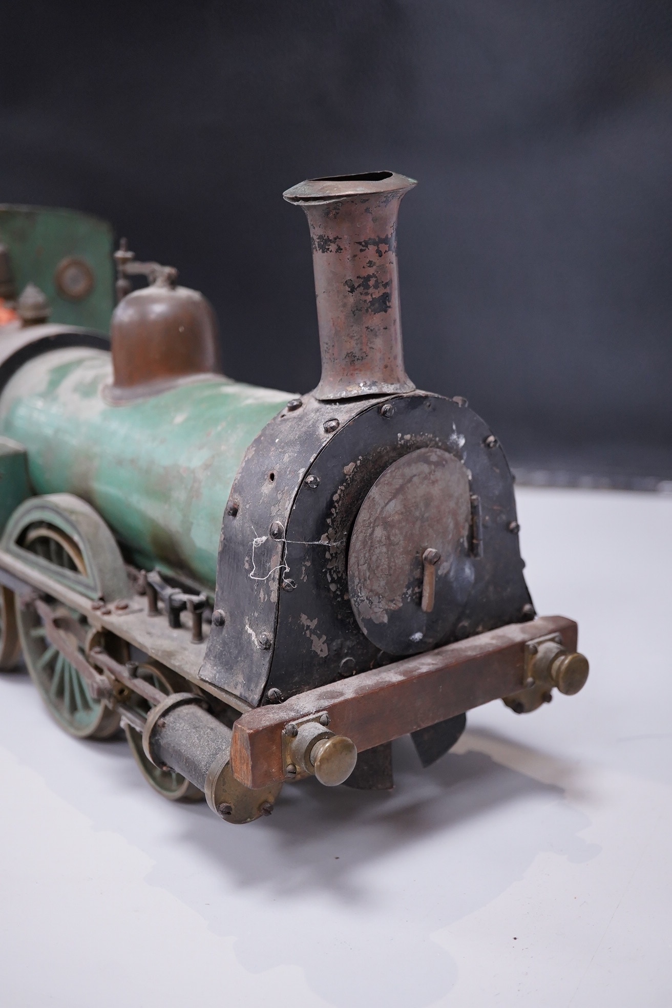 An early 20th century live steam four inch gauge 2-4-0 tender locomotive, possibly scratch built to a freelance design, spirit fired with two outside cylinders, Salter safety valve, reverser, whistle, etc. six wheel tend